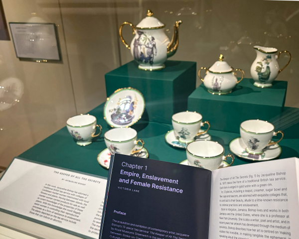 A tea service with teapot and cups with prints of collages of Caribbean market women and botanicals.