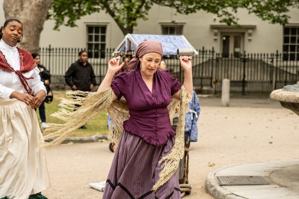 A person in a purple dress and headscarf