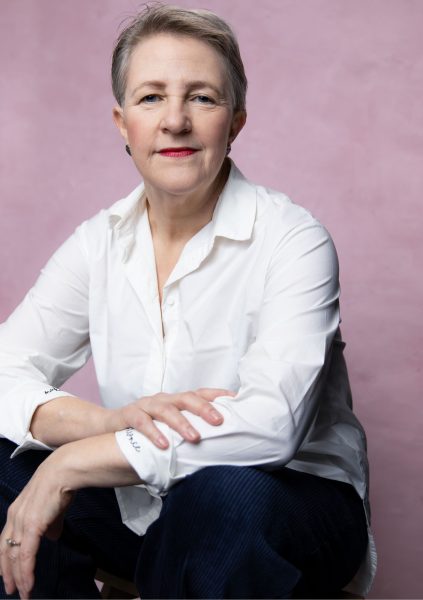 A person with red lipstick in a white shirt
