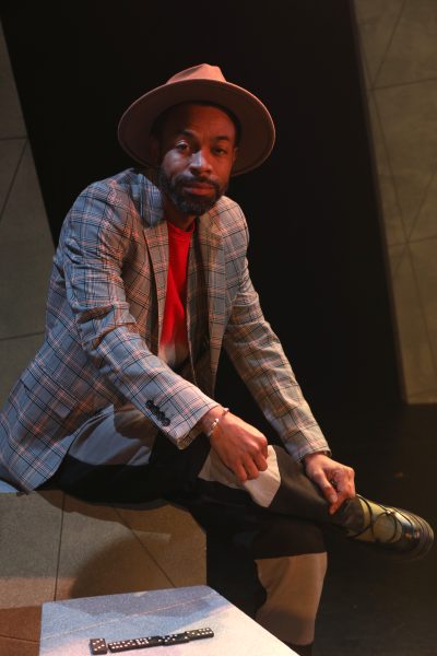 Man wearing brown fedora hat with a smile